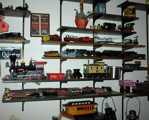Some of George's train-themed kit and caboodle on den shelves